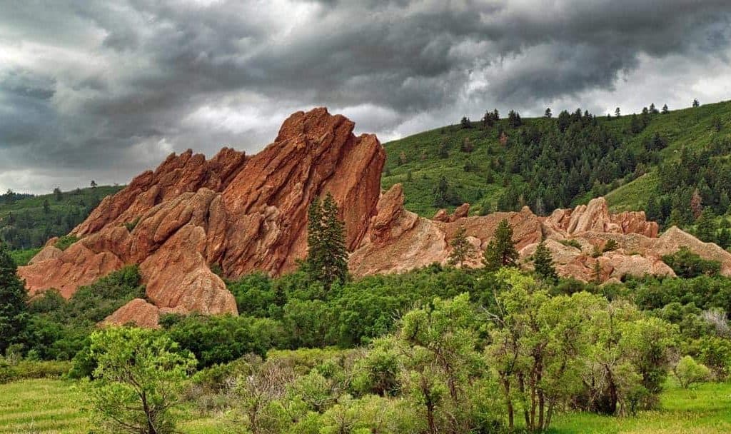 Dark storm clouds moving in over the striking red sandstone fountain formations at Roxborough State Park, Colorado.