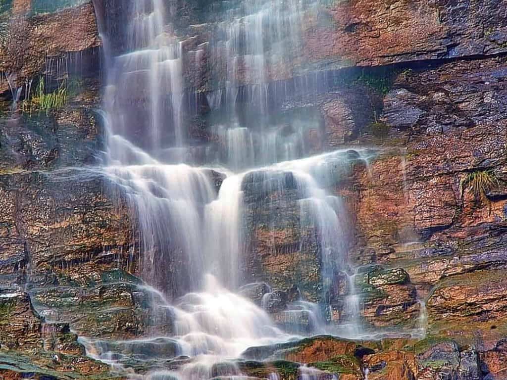 Lower Cascade Falls is visible from almost everywhere in Ouray, Colorado as it plummets several hundred feet down a steep rock face above 8th Street. This is a close-up image of the lower section of the falls just before it reaches the ground.