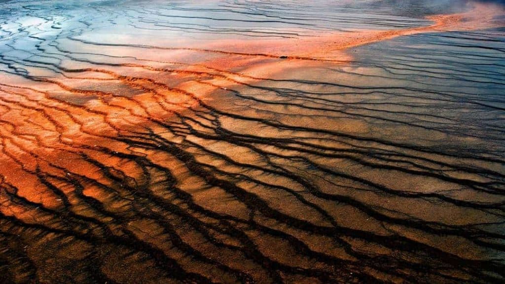 The colorful and fractured ground surrounding the Grand Prismatic Spring in Yellowstone National Park, Wyoming.