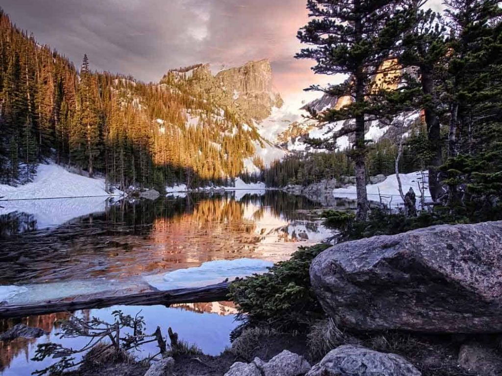 Dramatic dawn light falling over Dream Lake and Hallett Peak in Rocky Mountain National Park, Colorado.