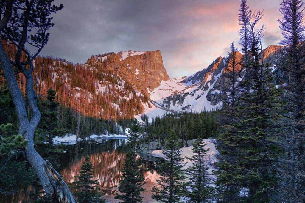 A colorful and moody sunrise at Dream Lake in Rocky Mountain National Park, Colorado.