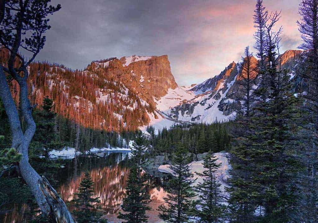 A colorful and moody sunrise at Dream Lake in Rocky Mountain National Park, Colorado.