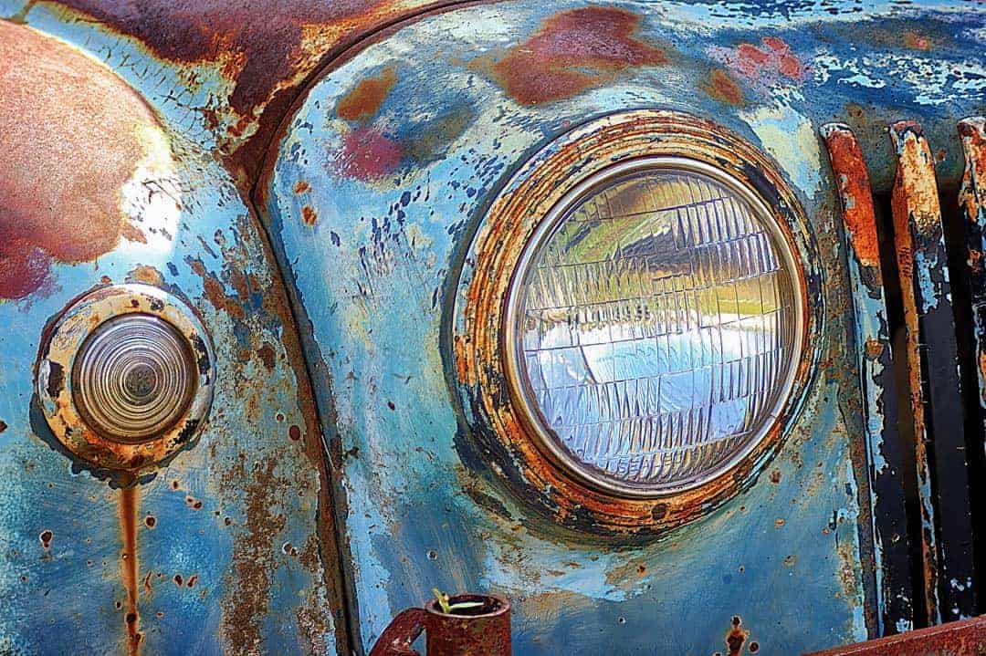 Rust stains and fading paint on an old pick-up truck left to weather in the central Texas elements make for a unique close-up.