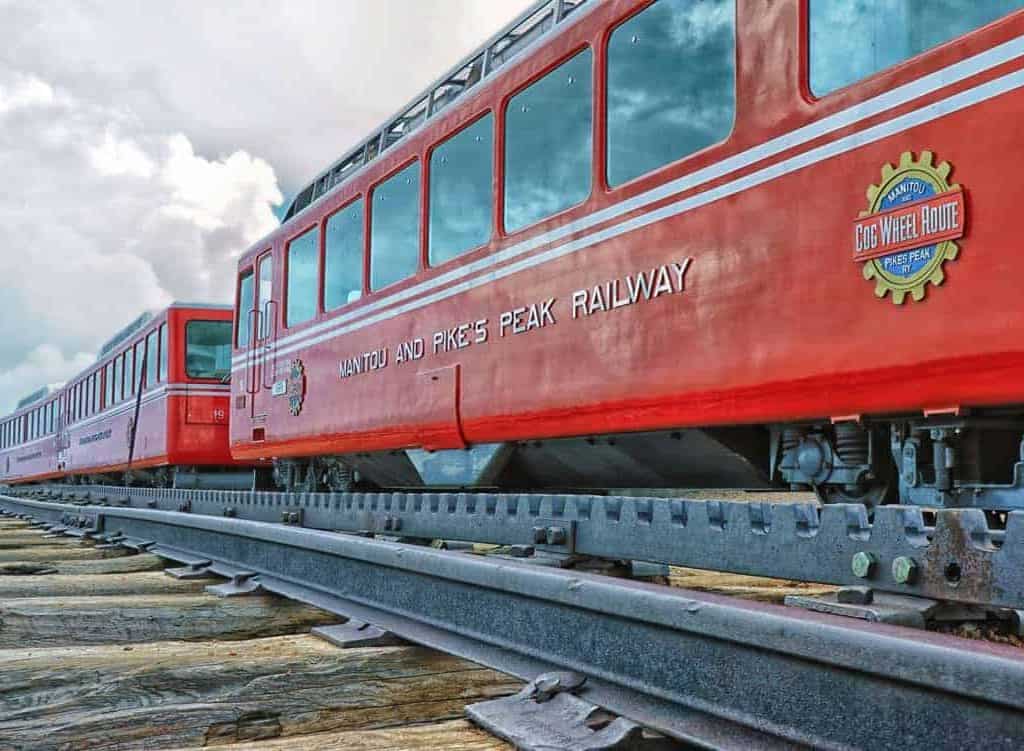 The bright red cars of the Pike's Peak Railway cog train at the summit of 14,115' Pike's Peak near Colorado Springs, Colorado.