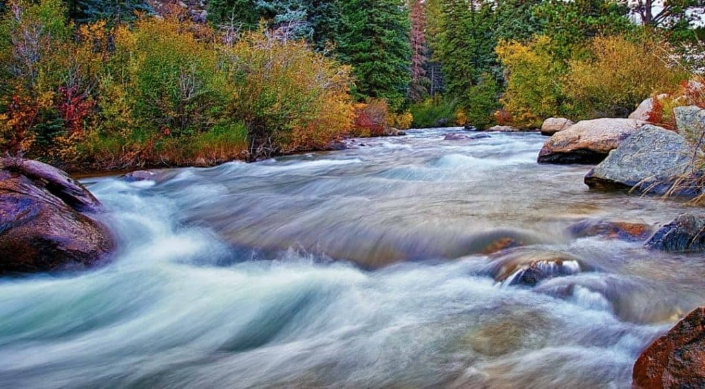 Autumn colors line the banks of the fast moving North Fork of the South Platte River near Bailey, Colorado.