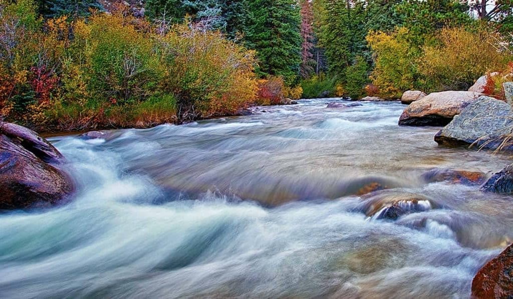 Autumn colors line the banks of the fast moving North Fork of the South Platte River near Bailey, Colorado.