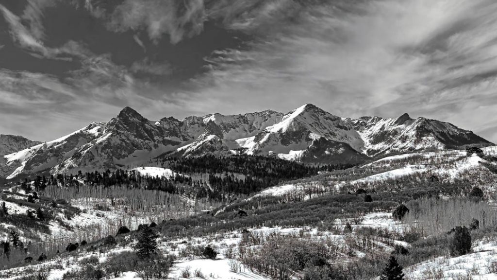 Black and white photo of rugged peaks of the San Juans at Dallas Divide Colorado in winter.