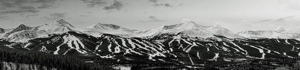 A late winter, multi-image panorama of the snow-capped peaks of Breckenride Ski Resort in Summit County, Colorado.