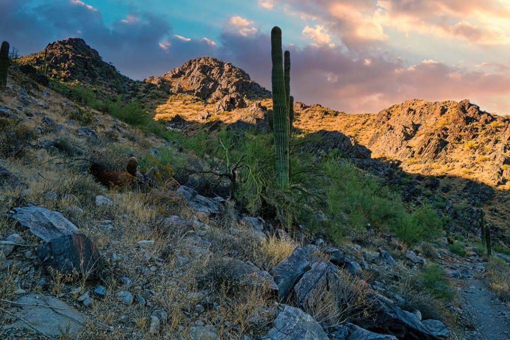 Beautiful dawn light breaking over the steep and rocky hillsides of the Phoenix Mountains in Arizona.