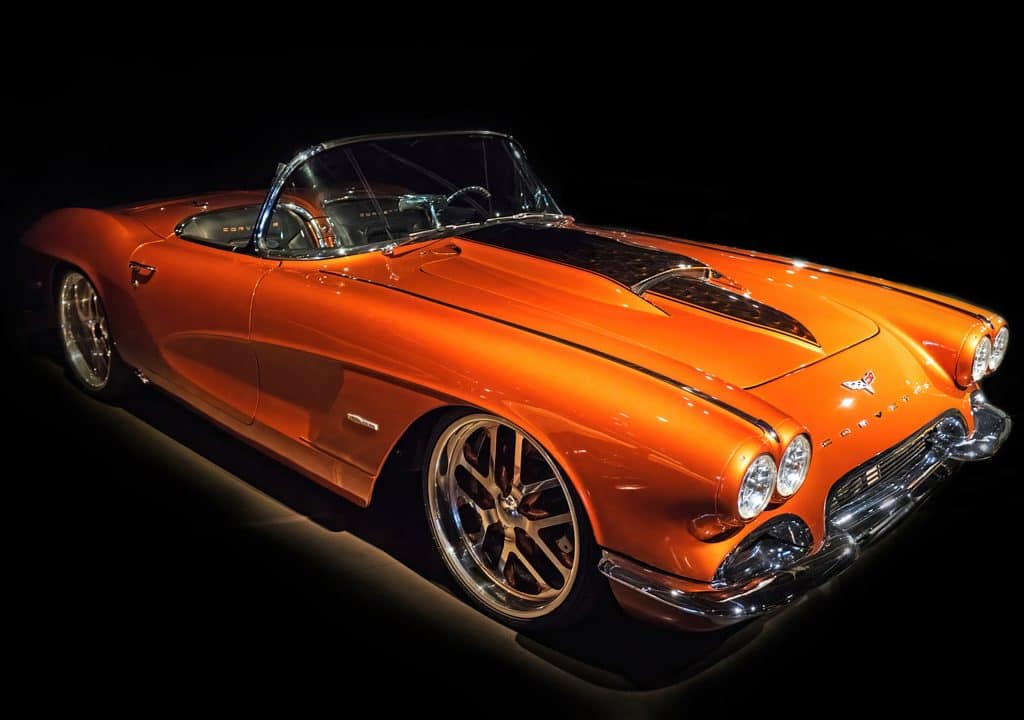 A customized and restored 1959 Chevrolet Corvette convertible in atomic orange.