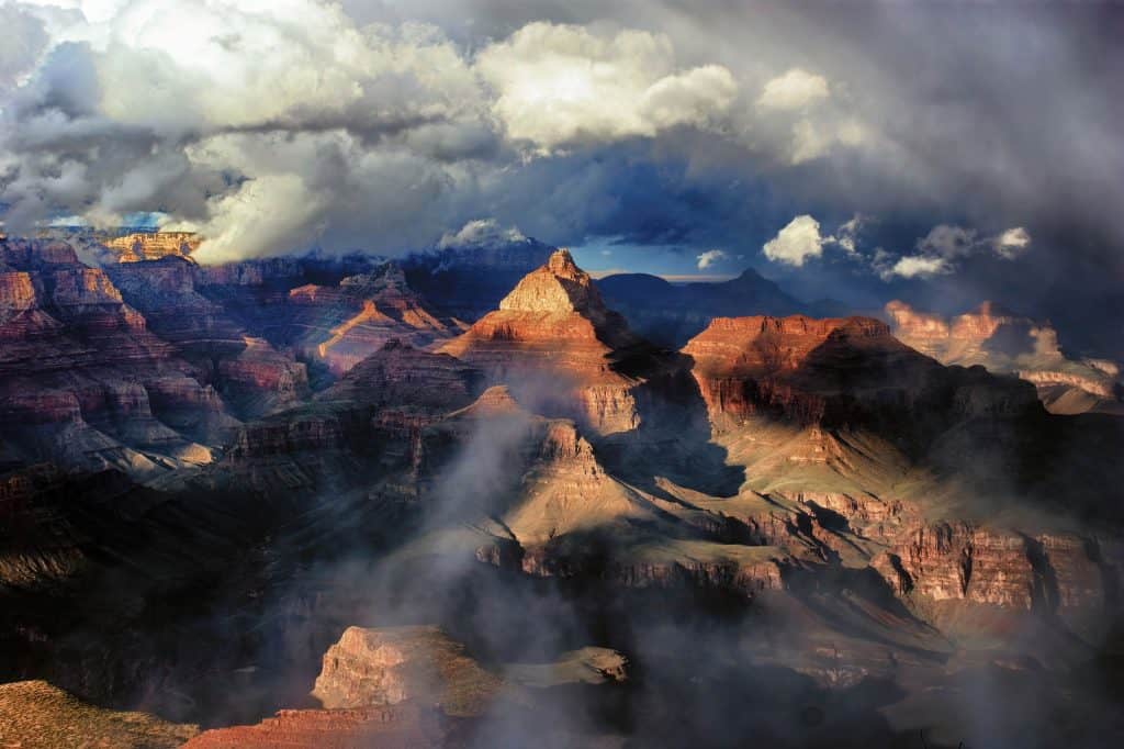  The Grand Canyon and surrounding storm clouds illuminated in the late afternoon light.