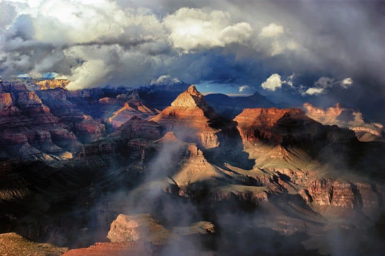  The Grand Canyon and surrounding storm clouds illuminated in the late afternoon light.
