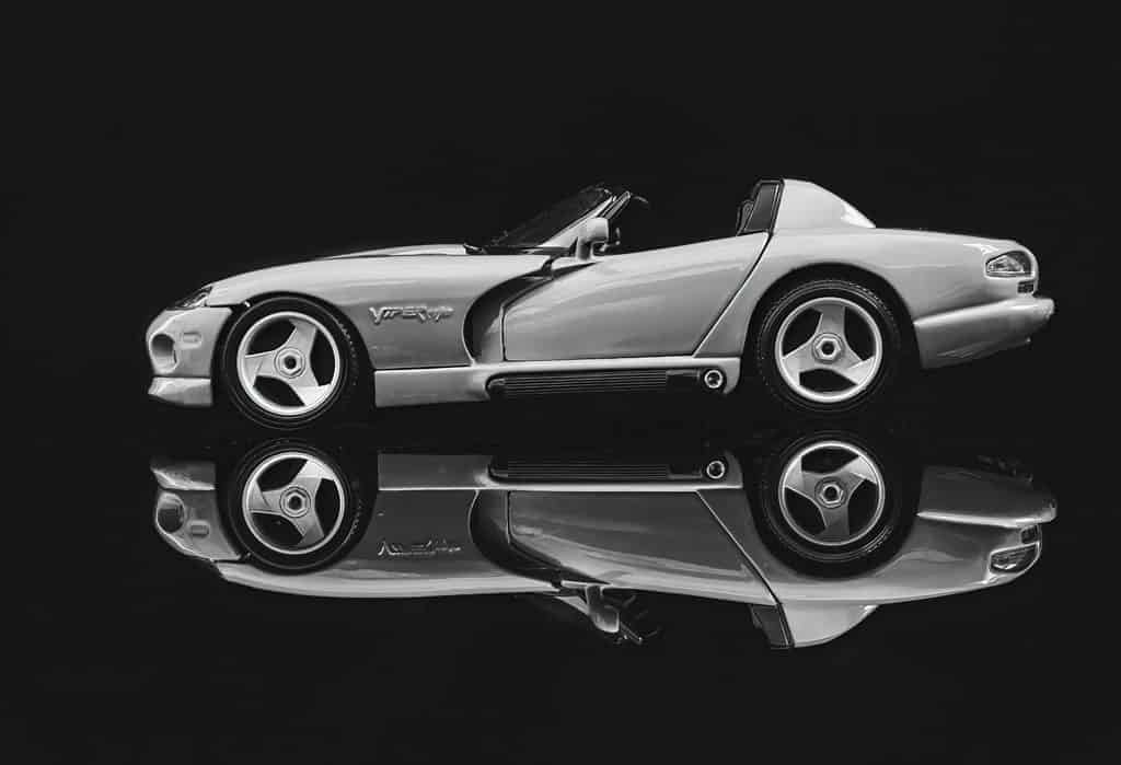 A Dodge Viper RT/10 sports car reflected against a black background.