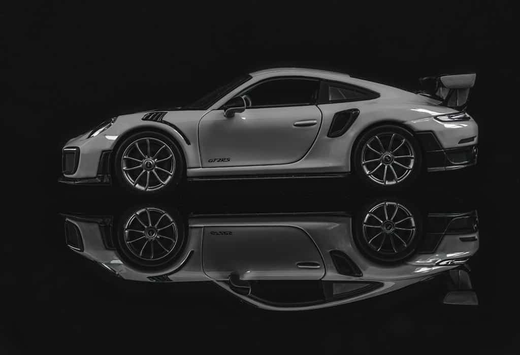 Black and white photo of 2018 Porsche 911 GT2 RS reflected against a black background