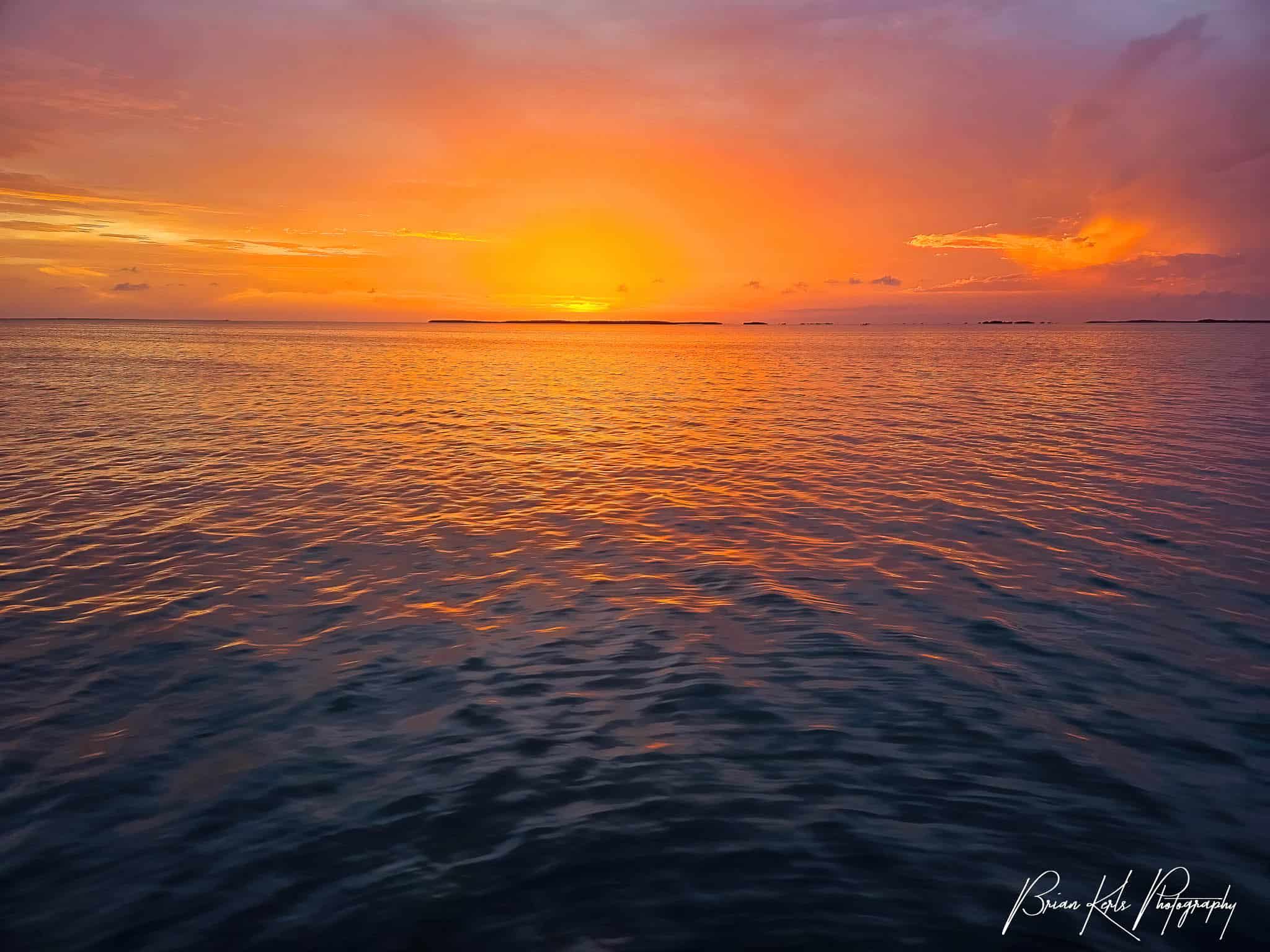 Striking orange sunset over the ocean seen from Key Largo, Florida.