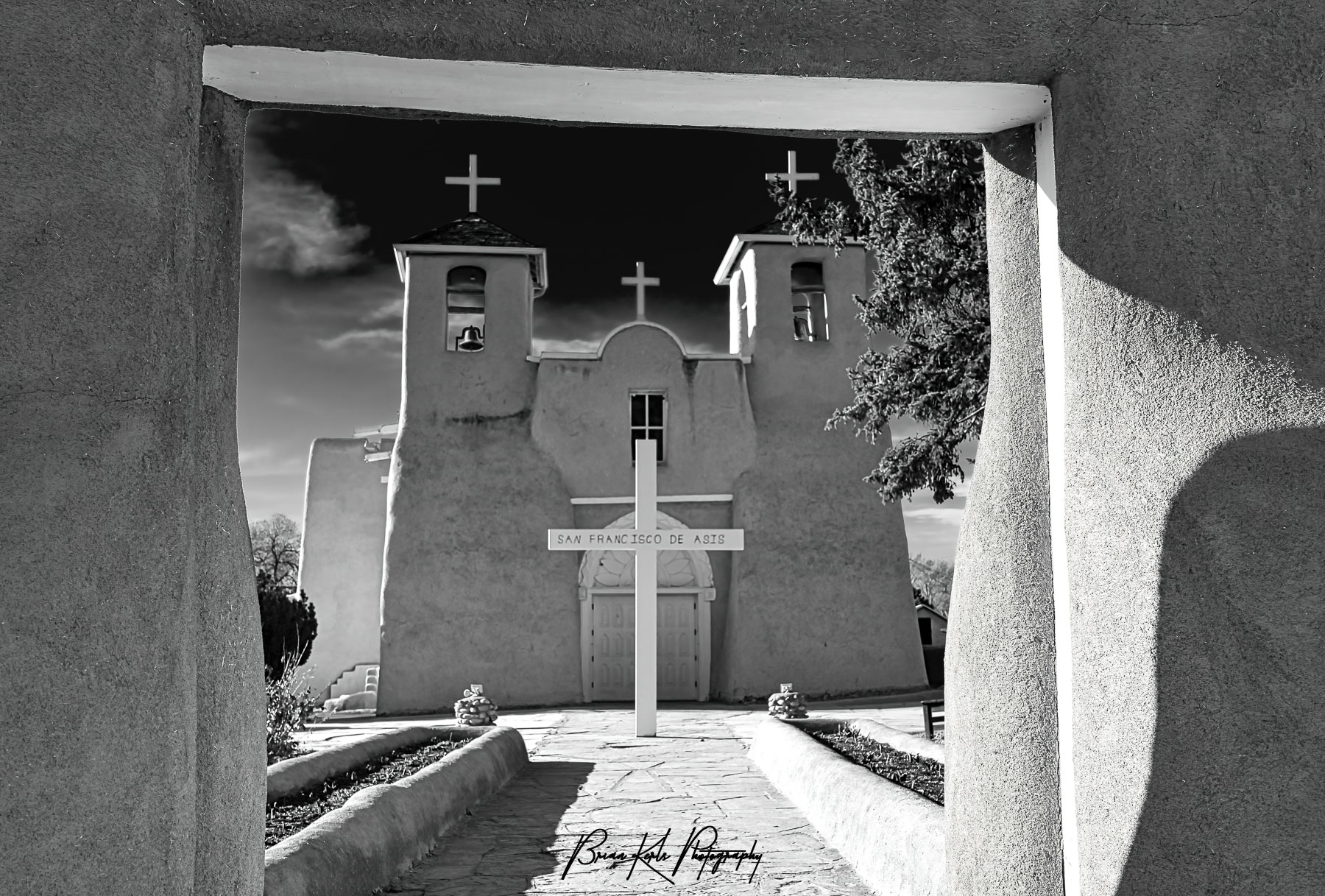 The historic San Francisco de Asis church in Rancho de Taos, New Mexico on a sunny late winter afternoon. With its twin bell towers and arched entry, this adobe church from the early 1800's blends Spanish colonial architecture and the building techniques of the Taos Pueblo people. Made famous by Ansel Adams and Georgia O'Keefe it is a National Historic Landmark and still an active church today.