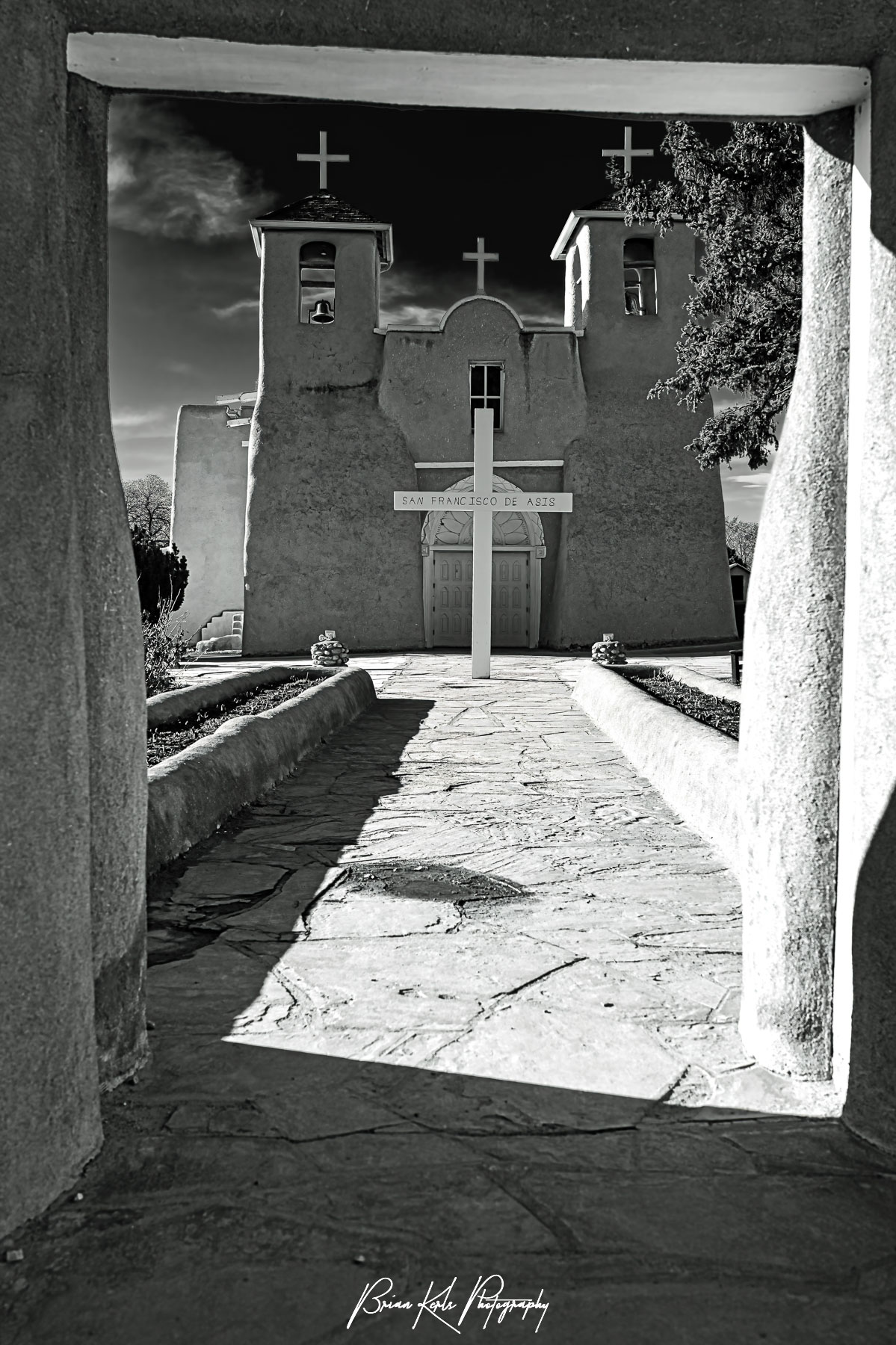 The historic San Francisco de Asis church in Rancho de Taos, New Mexico on a sunny late winter afternoon. With its twin bell towers and arched entry, this adobe church from the early 1800's blends Spanish colonial architecture and the building techniques of the Taos Pueblo people. Made famous by Ansel Adams and Georgia O'Keefe it is a National Historic Landmark and still an active church today.