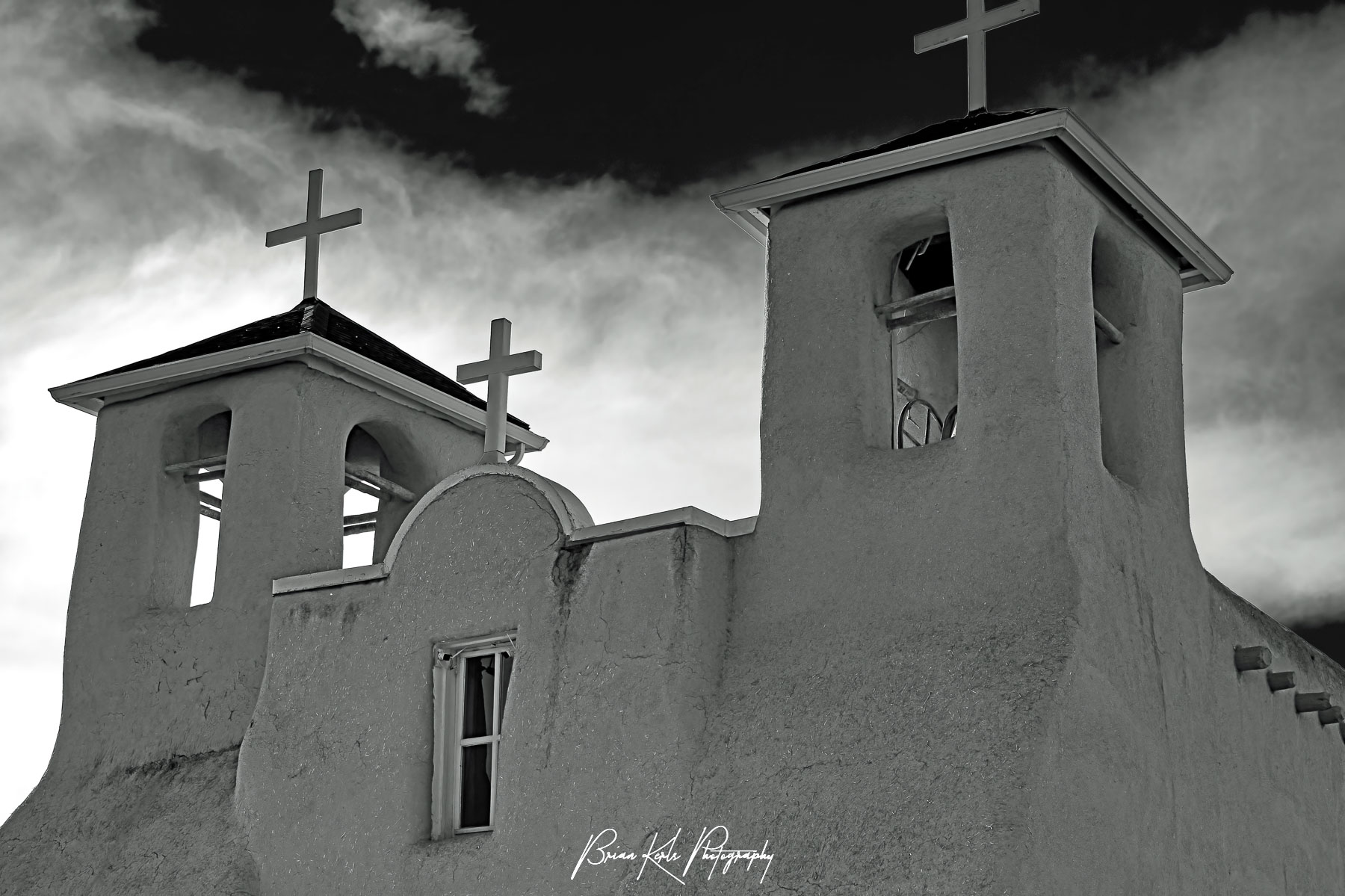 The historic San Francisco de Asis church in Rancho de Taos, New Mexico on a sunny late winter afternoon. With its twin bell towers and arched entry, this adobe church from the early 1800's blends Spanish colonial architecture and the building techniques of the Taos Pueblo people. Made famous by Ansel Adams and Georgia O'Keefe it is a National Historic Landmark and still an active church today.