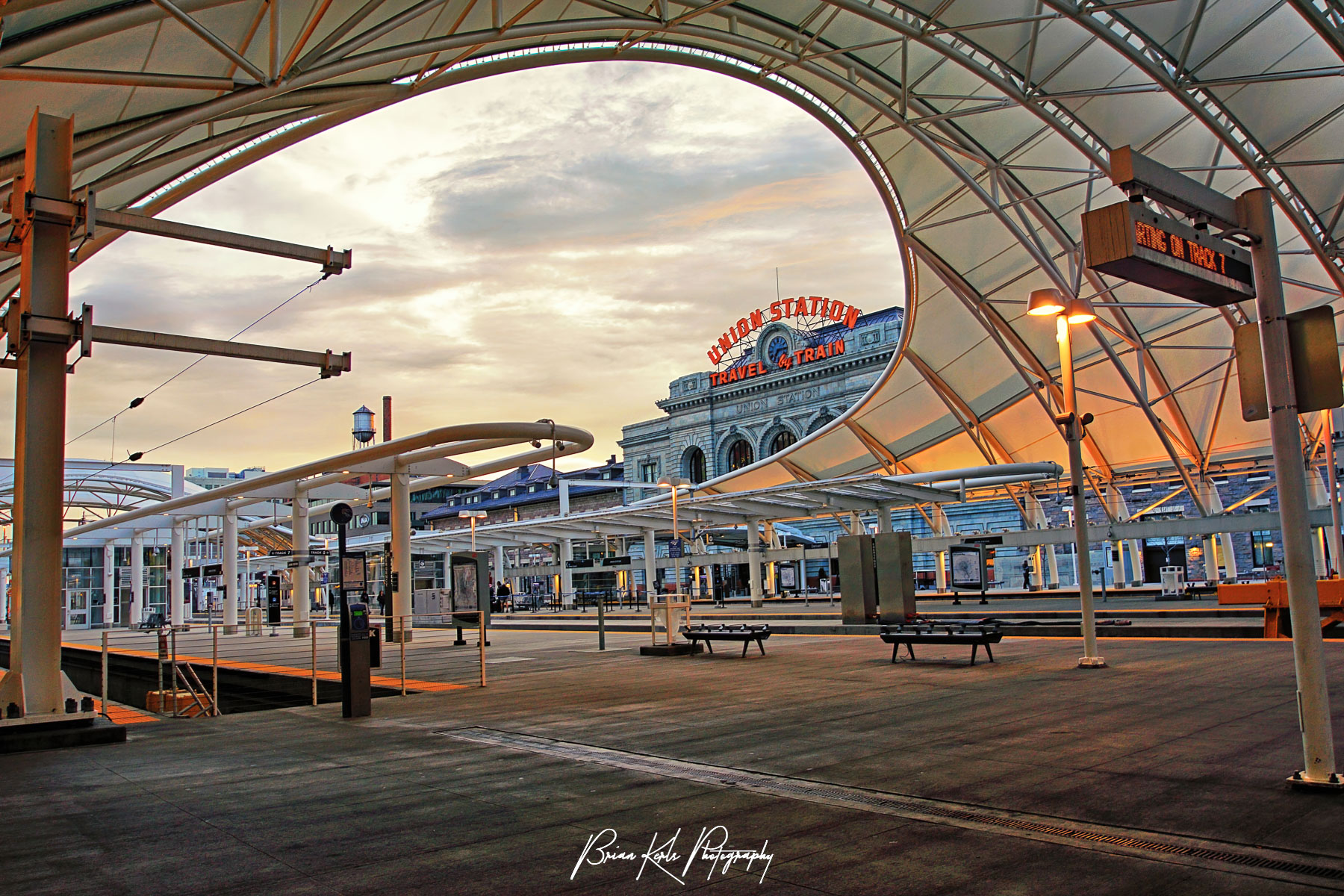 Distinctive modern structure of new light rail concourse contrasts with original vintage Union Station facade on an early morning in downtown Denver, Colorado.