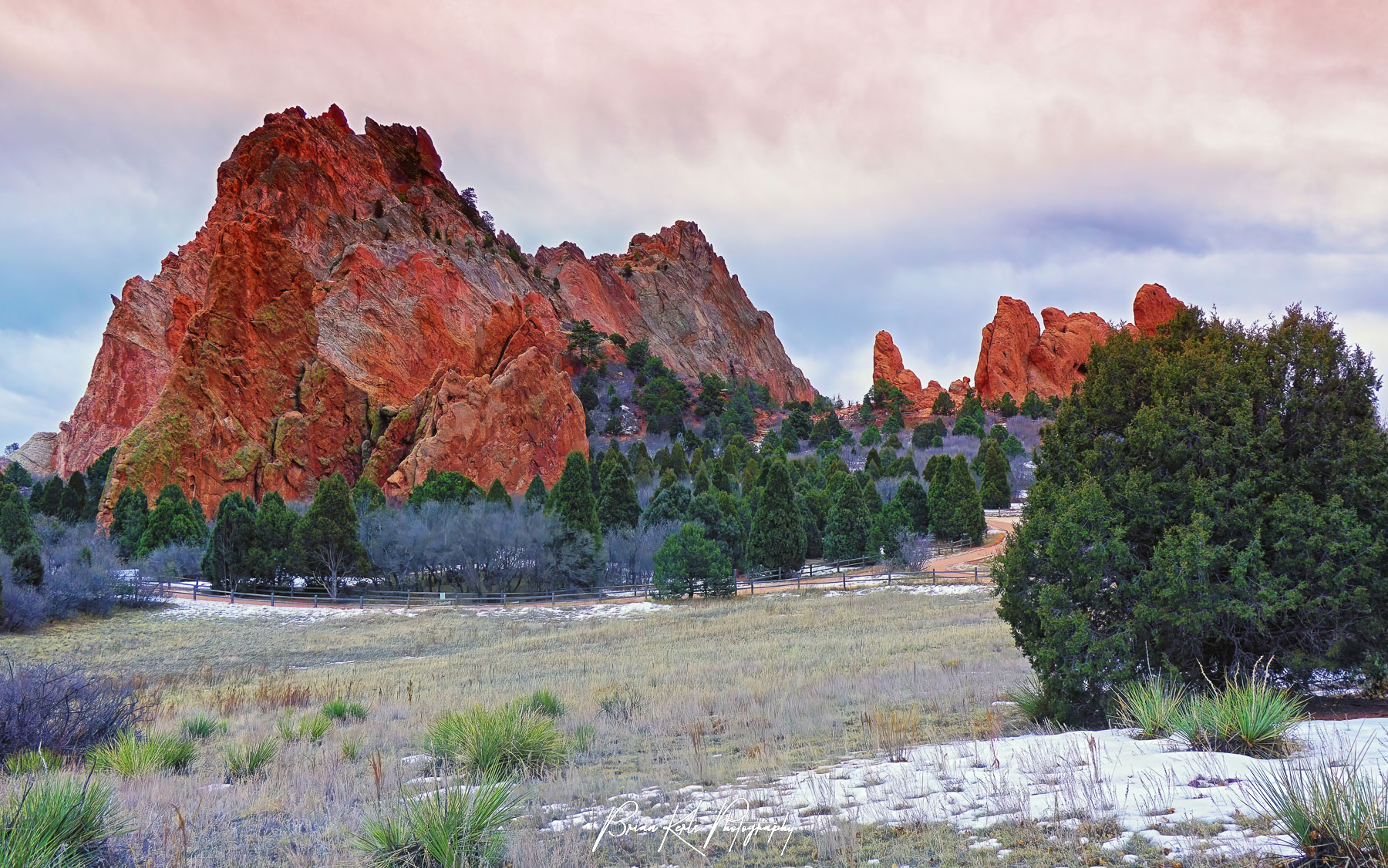 Pink sunrise sky a little after dawn on a cold winter morning at Garden of the Gods park in Colorado Springs, Colorado.