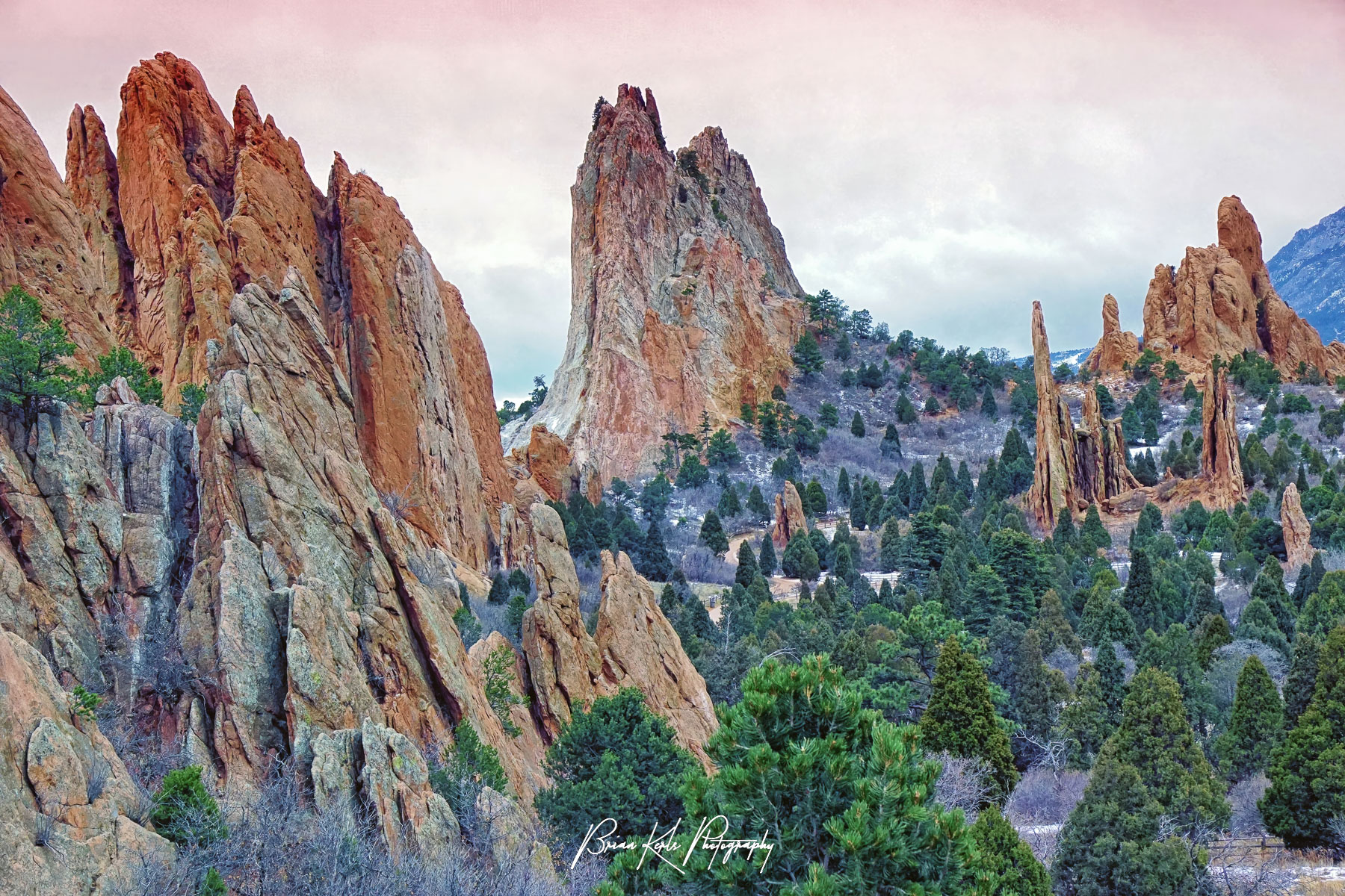 The impressive red rock formations at Garden of the Gods under a pink dawn winter sky.