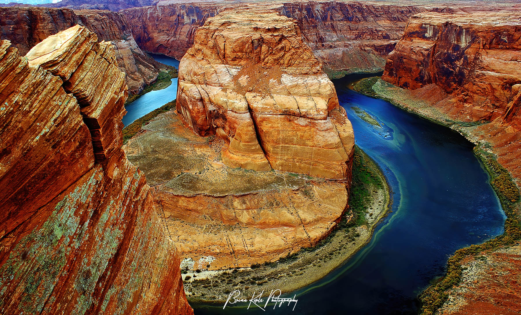 As it makes its way south and west toward the Grand Canyon, the Colorado River flows around the distinctive Horseshoe Bend near Page, Arizona. A short hike from the trailhead brings you to the edge of the canyon and a striking view of Horseshoe Bend and the Colorado River 1,000 feet below. This very poplar area has been photographed countless times, typically with a wide angle view showing the full width of the bend in the river. For a more unique perspective I chose a different viewpoint which captures both the bend in the river and the dramatic cliff jutting over the water.