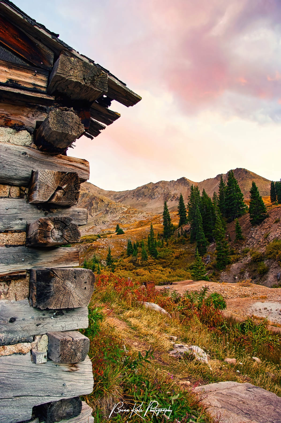 An interesting perspective of the Ten Mile Range under a colorful autumn sunset sky from one of several ruined mining cabins that make up what's left of the Old Boston Mine in the Mayflower Gulch area of Summit County, Colorado.