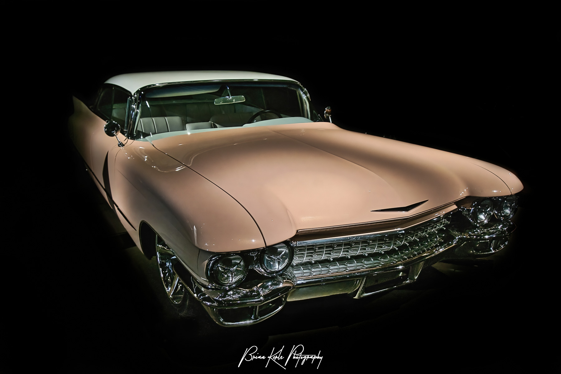 A well-restored, classic, late 1950's pink Cadillac coupe.