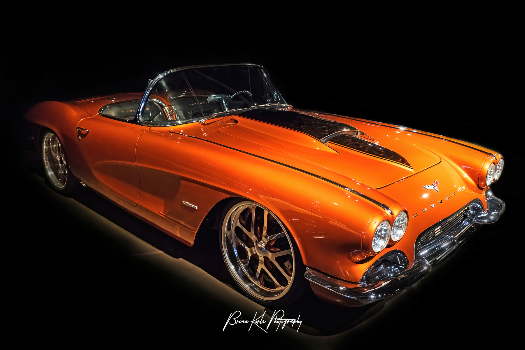 A customized and restored 1959 Chevrolet Corvette convertible in atomic orange.