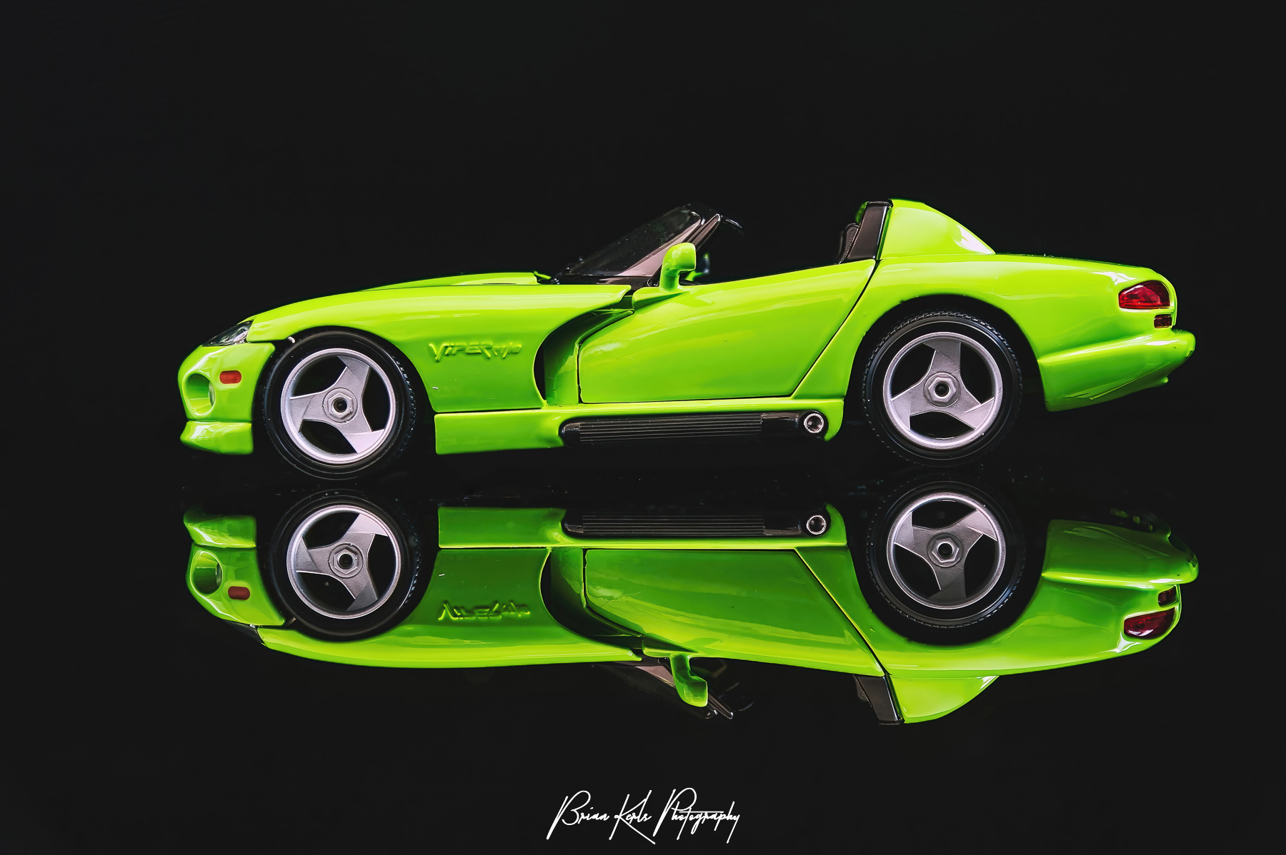 The Dodge Viper RT/10 roadster's impressive V10 engine puts out 450 horsepower and a top speed of 206 mph. The lime green version shown here is striking reflected against the black background.