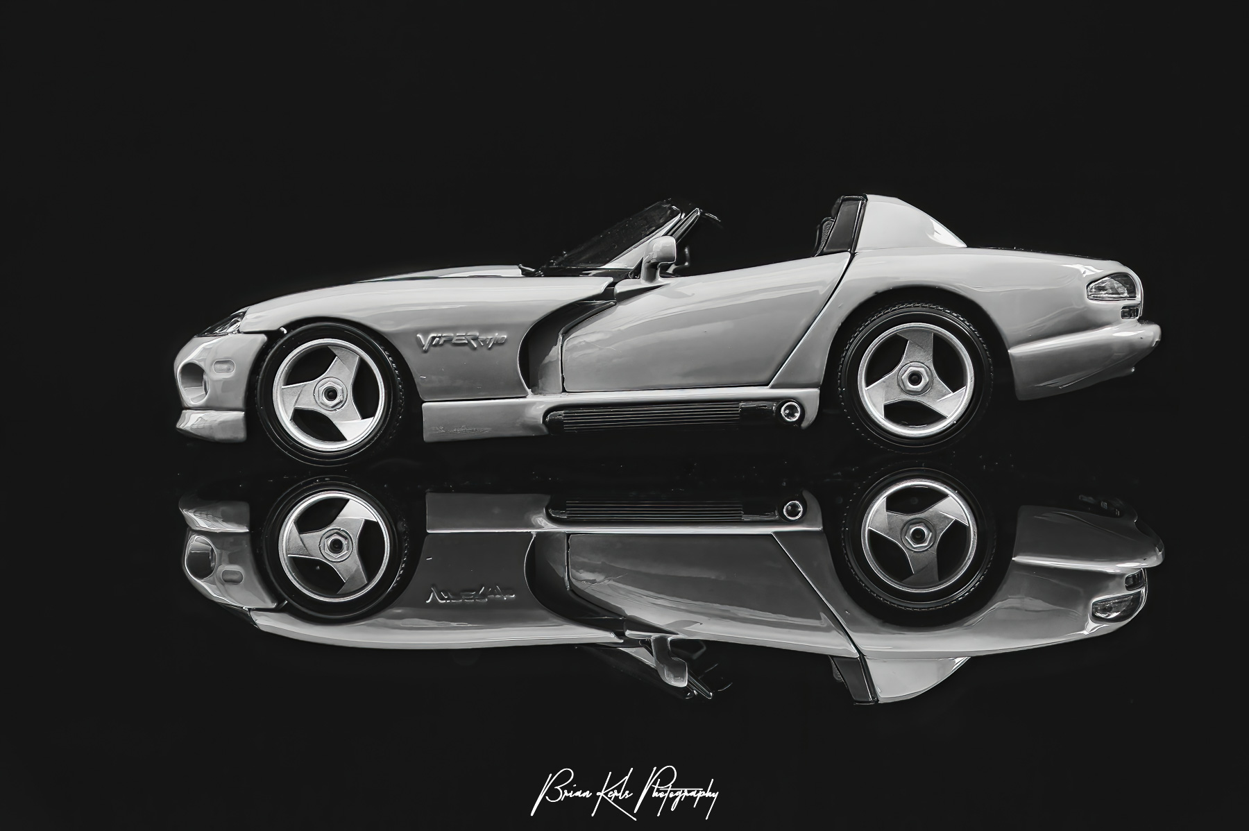 The Dodge Viper RT/10 roadster's impressive V10 engine puts out 450 horsepower and a top speed of 206 mph. The mirror image shown here is striking against the black background.