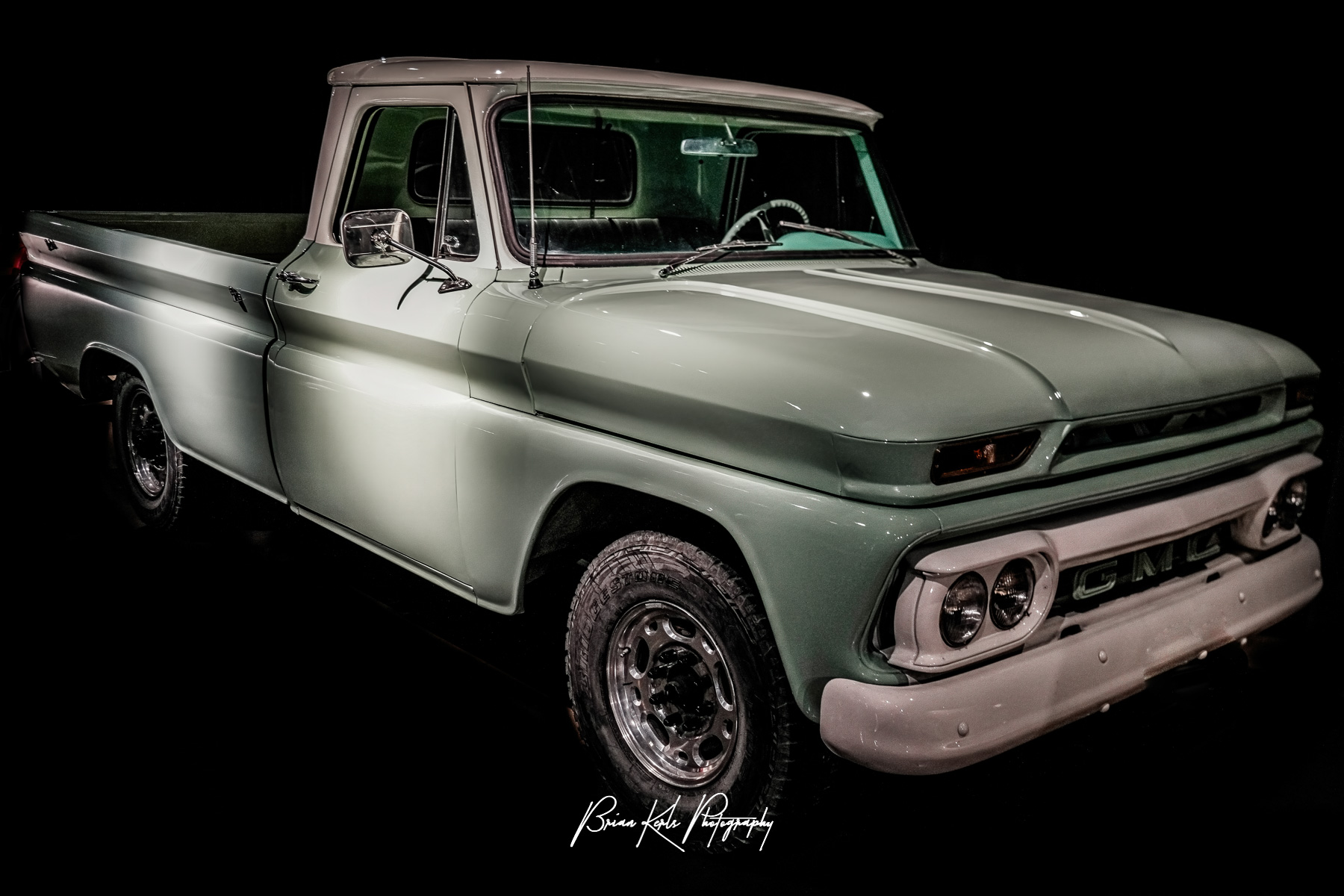 A nicely restored vintage GMC 1966 C10 pick up truck in light green paint.