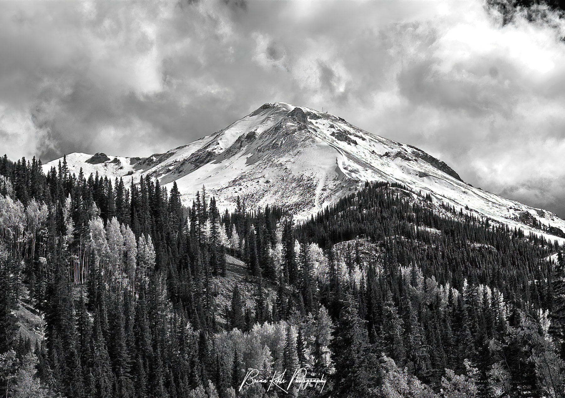 Early season snow covers Red Mountain as the aspens along its flanks begin to change color. This image was shot from the shores of Crystal Lake along the Million Dollar Highway south of Ouray, Colorado.