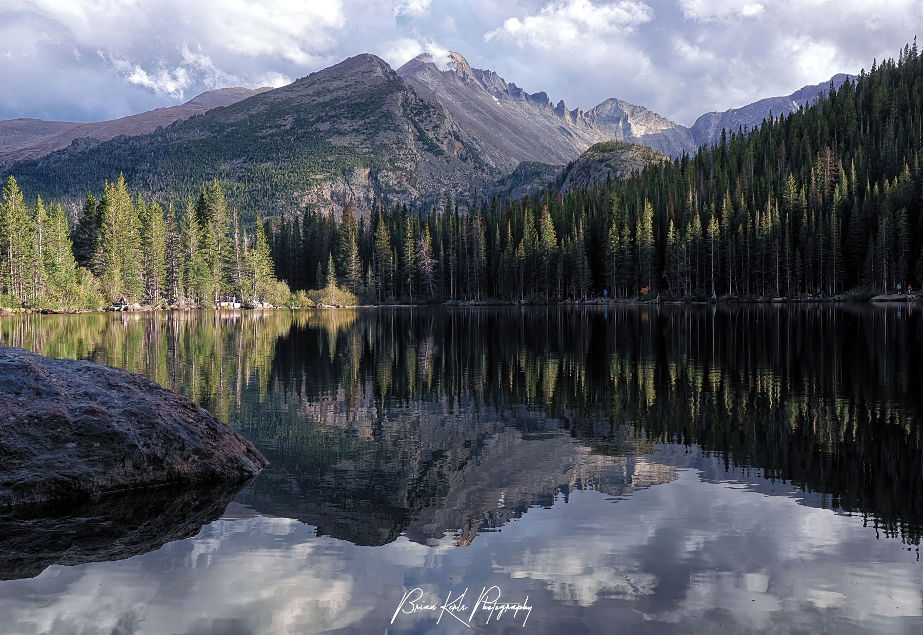 Longs Peak reflected in the still water of Bear Lake in Rocky Mountain National Park, Colorado on an early fall evening. At 14,259', Longs Peak is the highest point in Rocky Mountain National Park and the northernmost 14er in the Rocky Mountains.