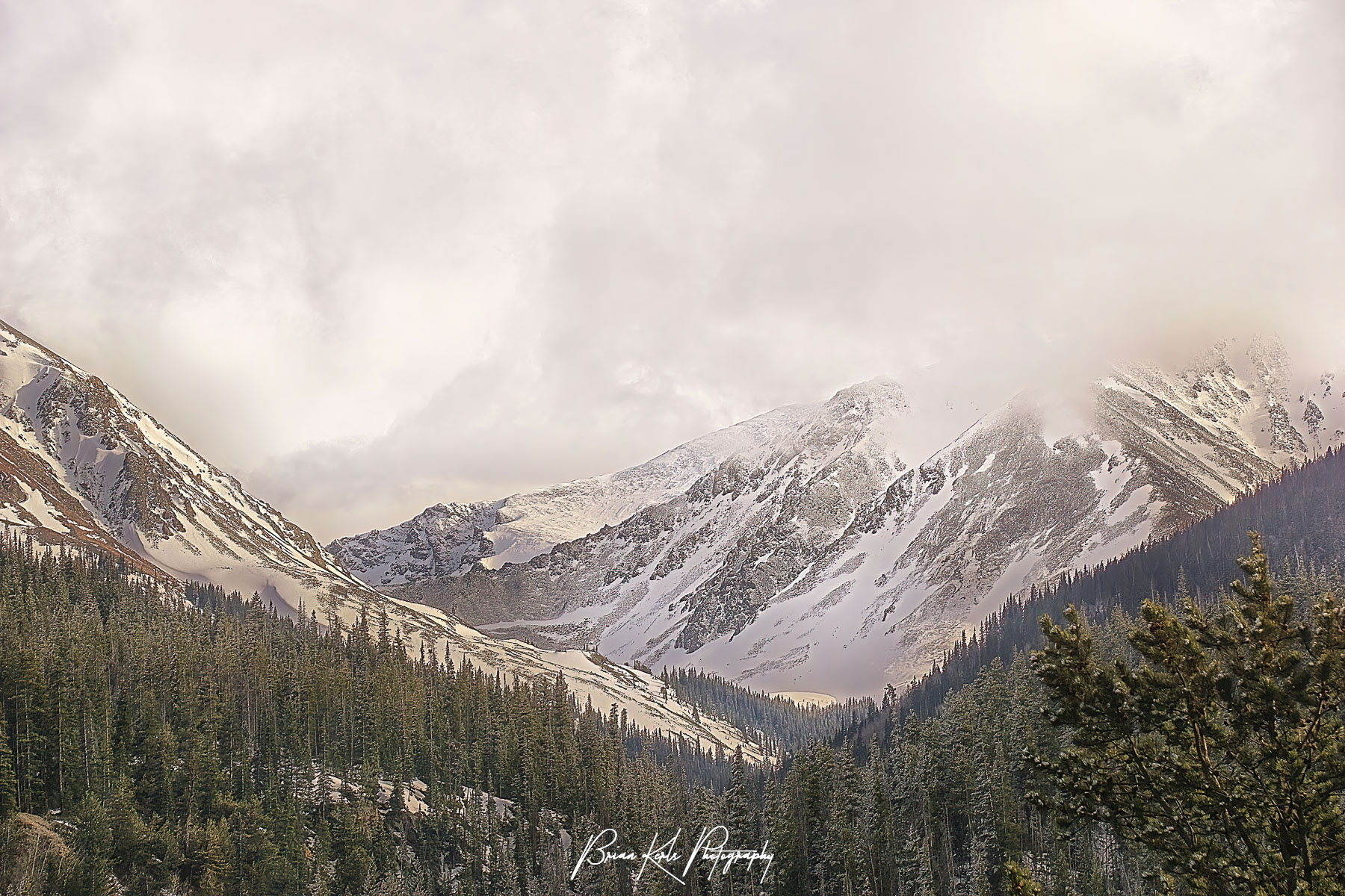 Driving through the mountains after a spring snow storm I was captivated by this fleeting vista. The afternoon sun was illuminating the lower portions of Grays and Torreys while their summits remained obscured by the remaining storm clouds. Luckily I had my camera along and was able to capture the scene before it faded away. At 14,270’ and 14,267’ Grays and Torreys are the two highest peaks along the Continental Divide and some of the more popular and accessible 14er’s in Colorado given their proximity to I-70 and Denver.