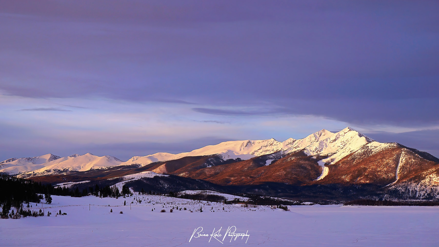 A moody "blue-hour" sunrise as the first light of day hits the rugged peaks of the Ten Mile Range in Summit County, Colorado.