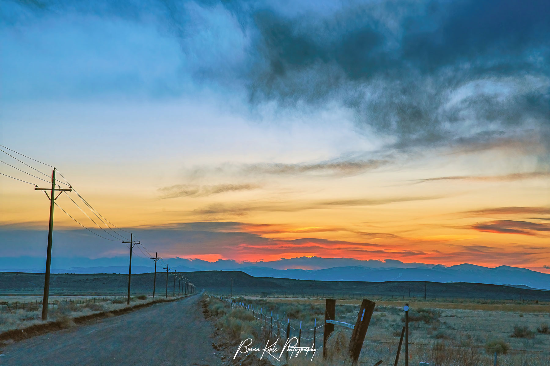 A dramatic late winter sunset over an empty road in rural Southern Colorado near the New Mexico border.