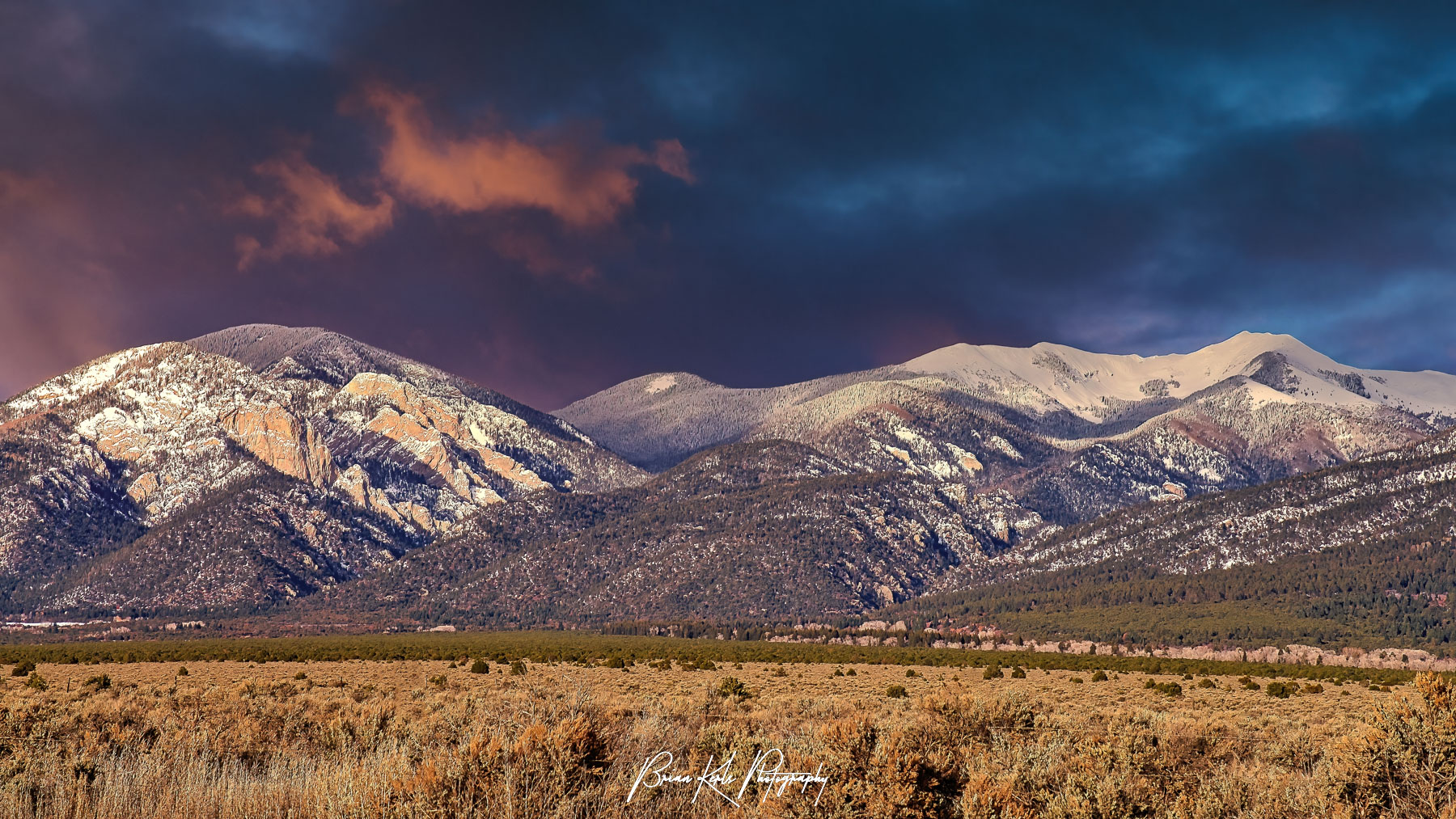 Colorful winter sunset over a snow capped Lucero Peak in the Sangre de Cristo Mountains outside Taos, New Mexico.