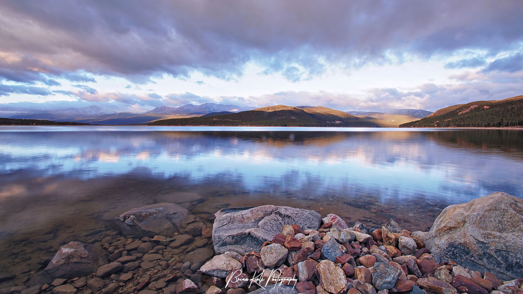 Dramatic early morning sky reflected in the still waters of Turquoise Lake, near Leadville, Colorado.