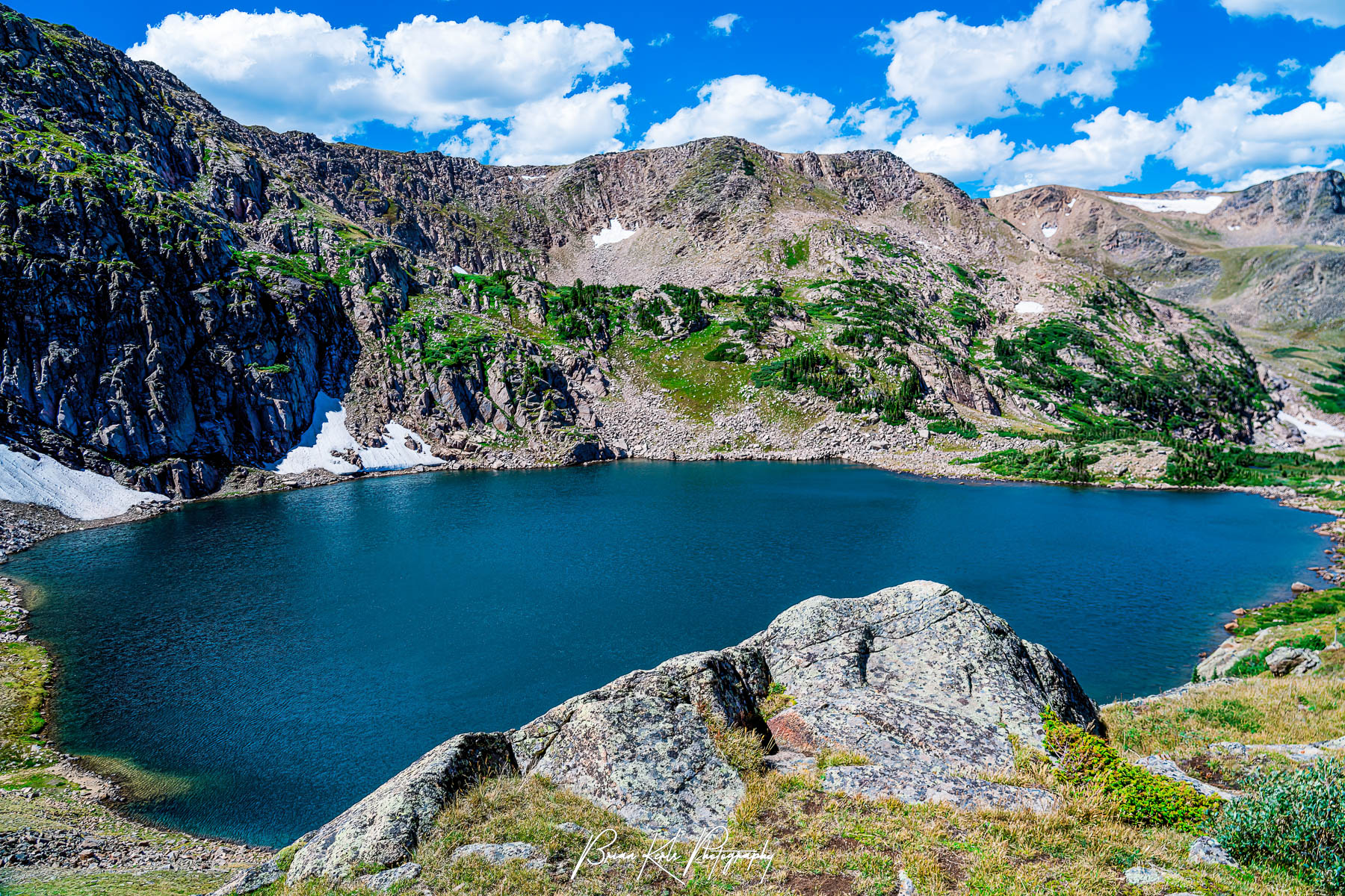 Nestled high in the Rocky Mountains of Colorado, just east of the Continental Divide, King Lake lies in a deep cirque at 11,340' at the head of spectacular alpine valley. Here the pristine, blue water of King Lake is framed by the cirque’s impressive vertical headwall to the west and the brilliant blue sky above.