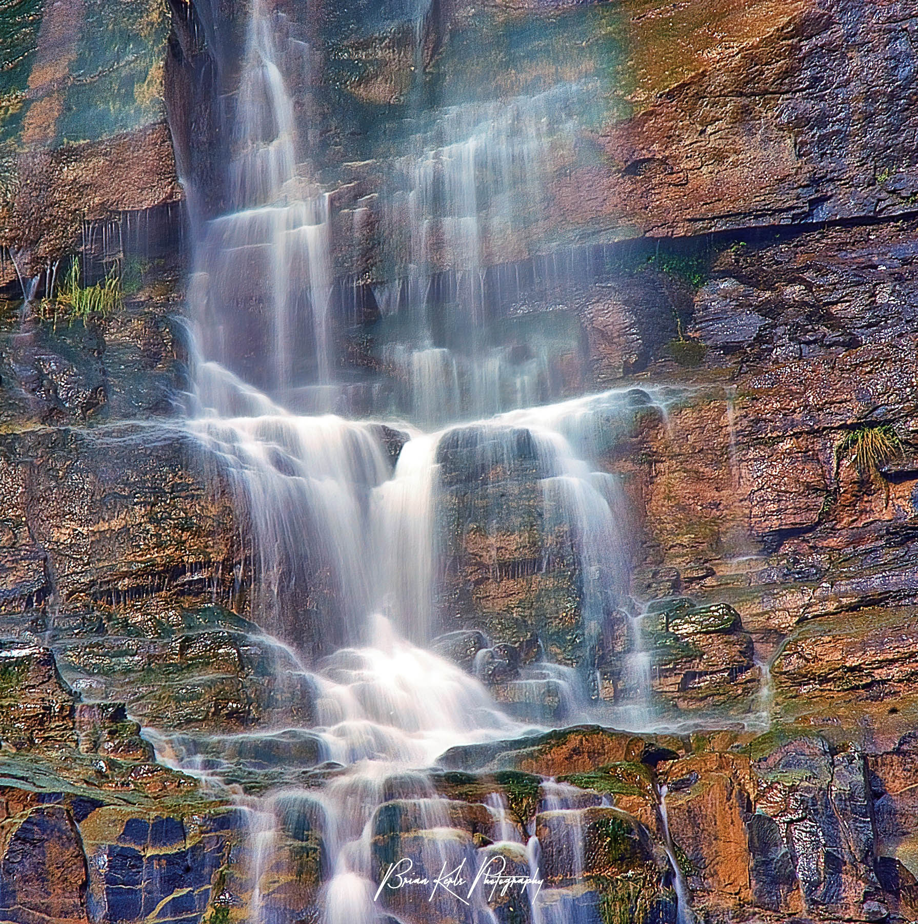 Lower Cascade Falls is visible from almost everywhere in Ouray, Colorado as it plummets several hundred feet down a steep rock face above 8th Street. This is a close-up image of the lower section of the falls just before it reaches the ground.