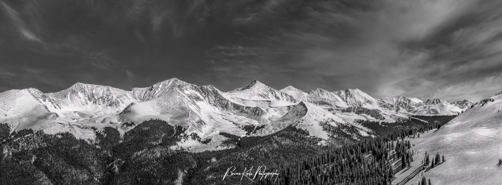 A seven image panorama of the rugged, snow-capped peaks of the Ten Mile and Mosquito Ranges from the 12,000' summit of Copper Mountain Ski Resort in Summity County, Colorado. Peak Ten is at the left, Pacific Peak and Atlantic Peak are towards the center, and Spaulding Bowl within Copper Mountain Ski Resort is in the foreground to the right.