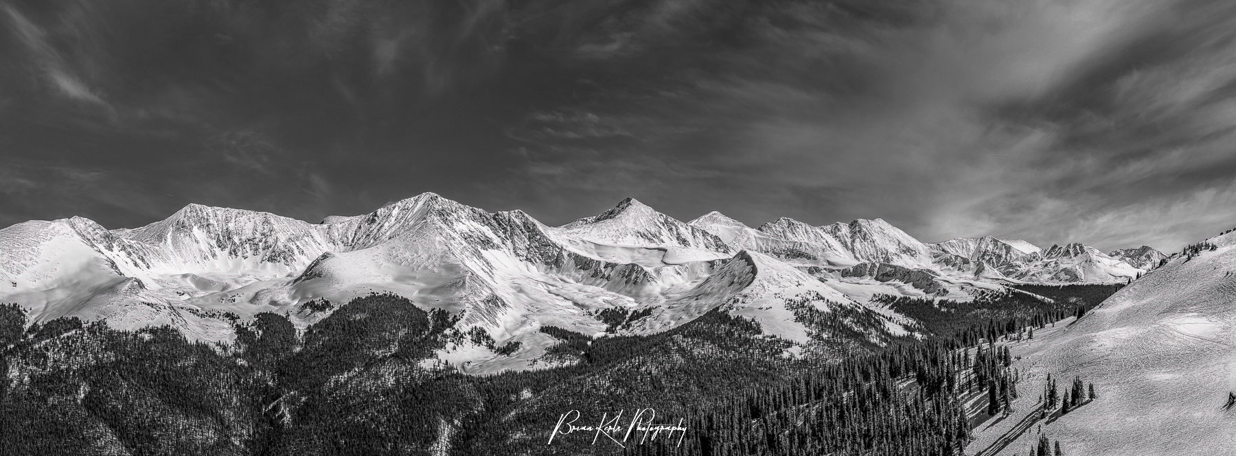 A seven image panorama of the rugged, snow-capped peaks of the Ten Mile and Mosquito Ranges from the 12,000' summit of Copper Mountain Ski Resort in Summity County, Colorado. Peak Ten is at the left, Pacific Peak and Atlantic Peak are towards the center, and Spaulding Bowl within Copper Mountain Ski Resort is in the foreground to the right.