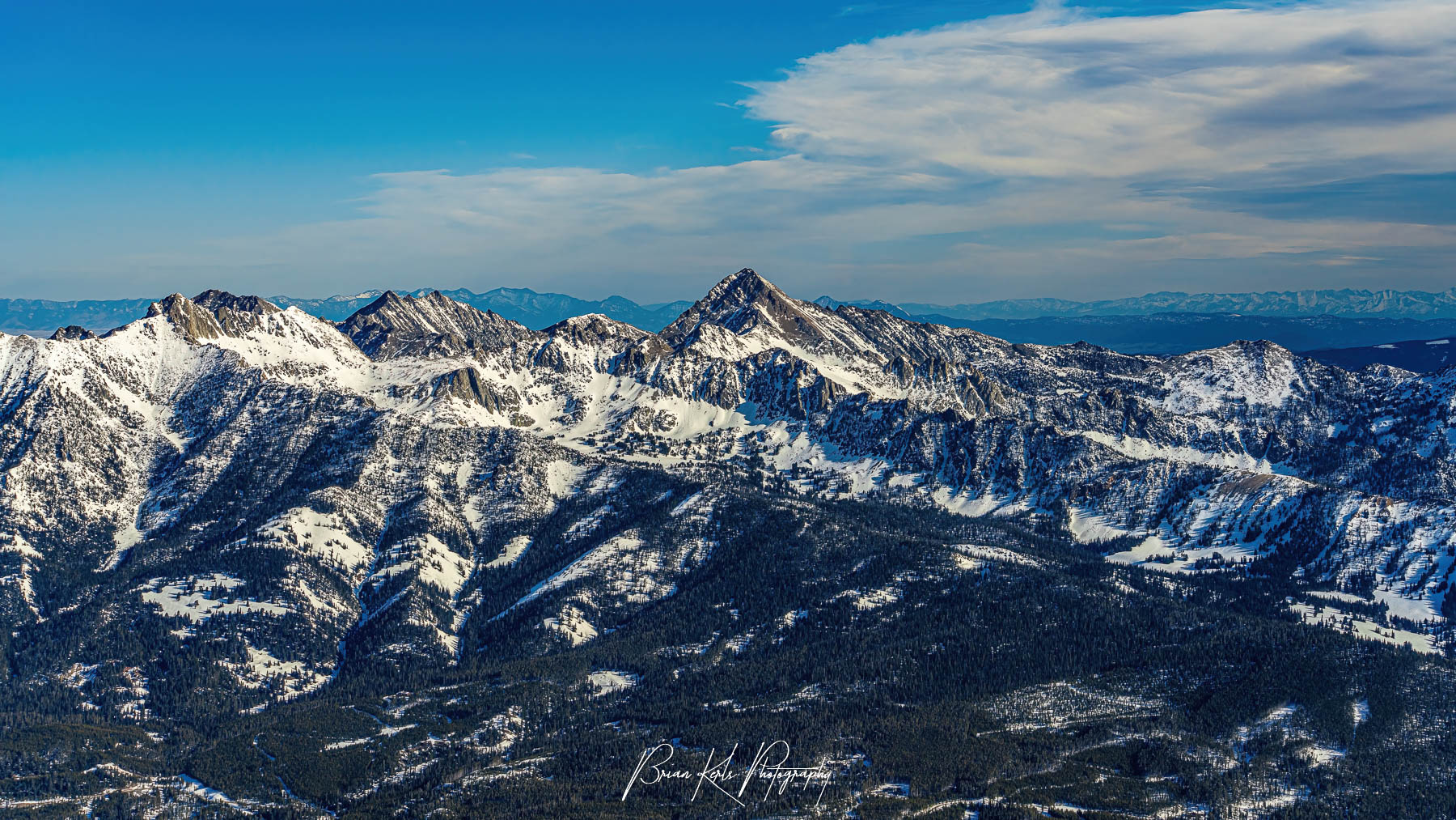 Sweeping ridge line with Gallatin Peak Ridge prominent in center as seen from summit of Lone Peak, Big Sky Montana.